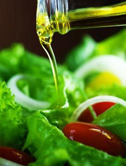 Dressing being poured on a salad