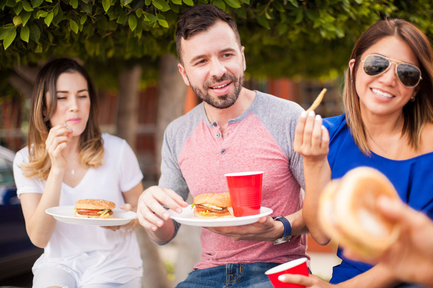 Friends eating burgers and having fun