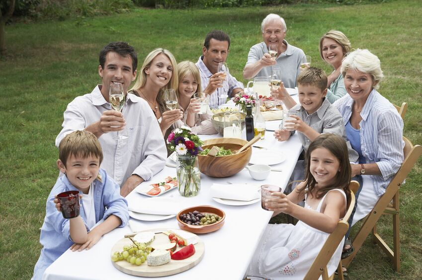 Group enjoying a meal and drinks at a family reunion